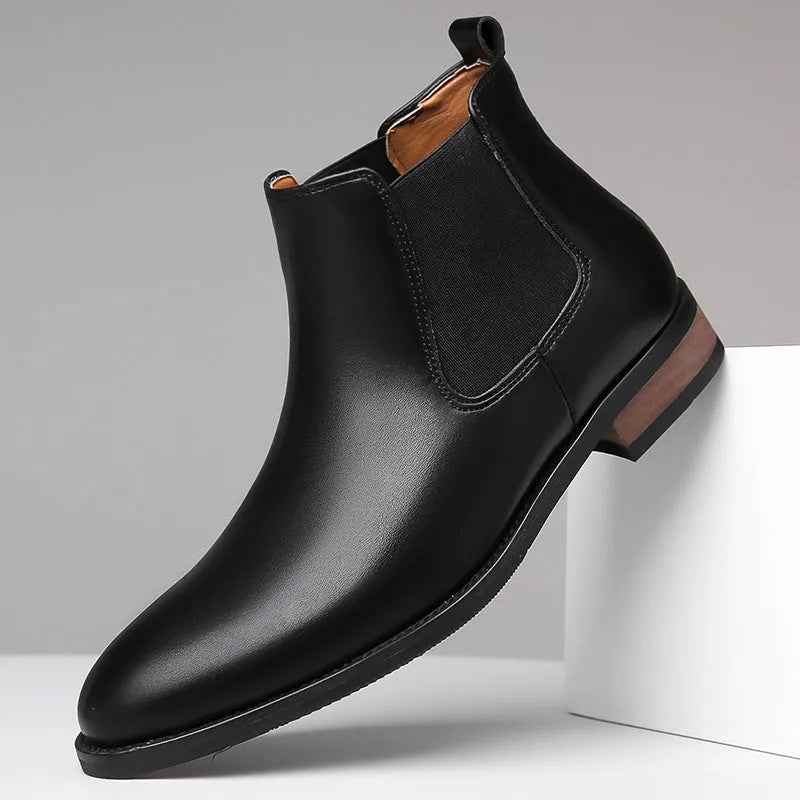 Men's black pointed-toe Chelsea ankle boot with a high-top silhouette and rubber sole.