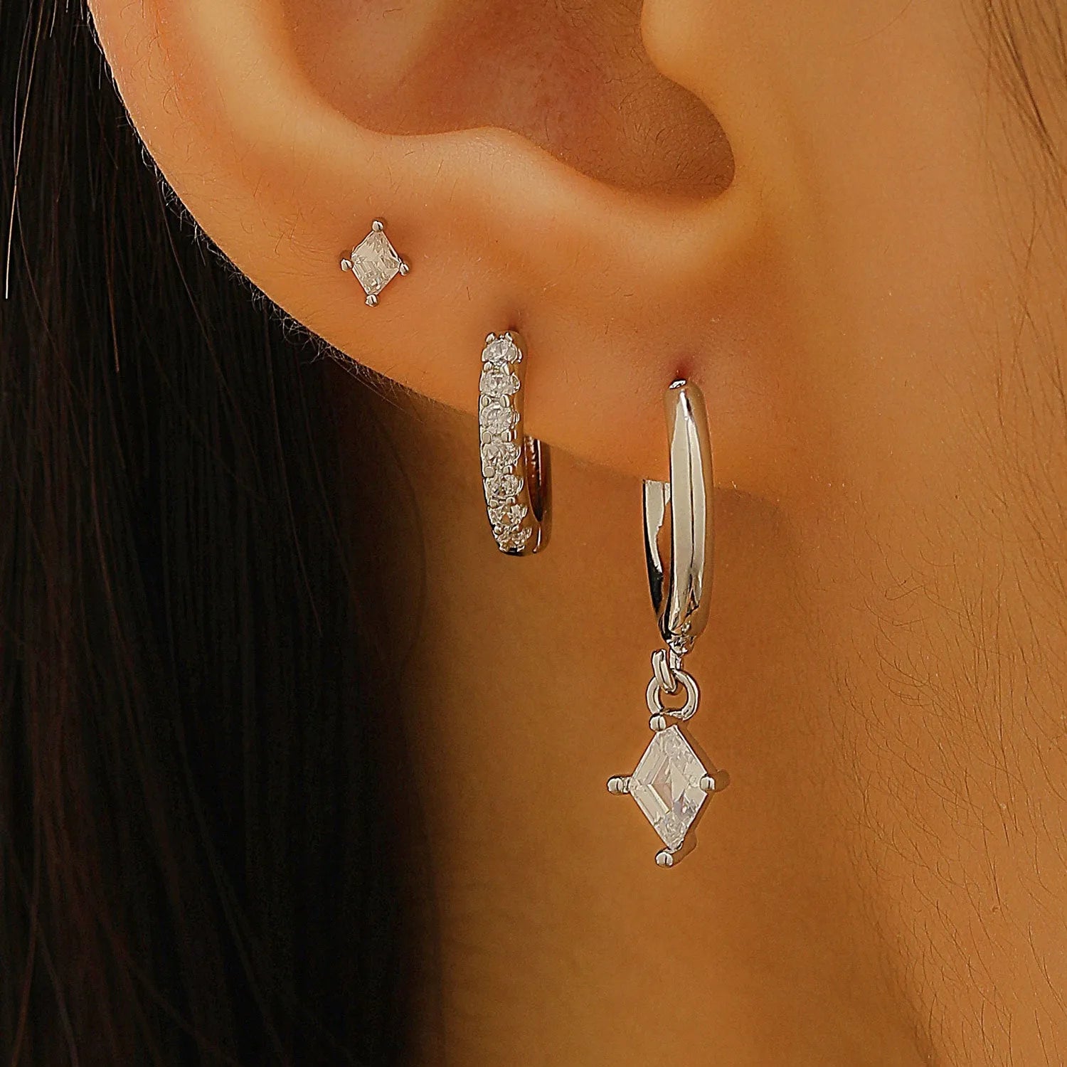 Geometric ladies earring set with zircon detailing in gold and silver options showing drop, stud, and clip-on pieces