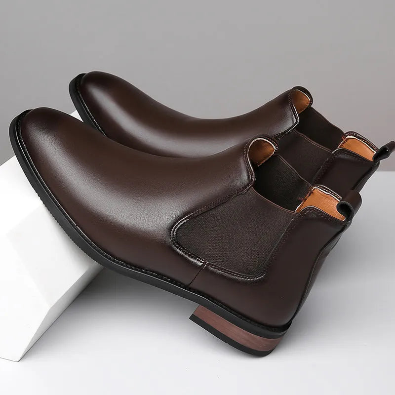Men's black pointed-toe Chelsea ankle boot with a high-top silhouette and rubber sole.