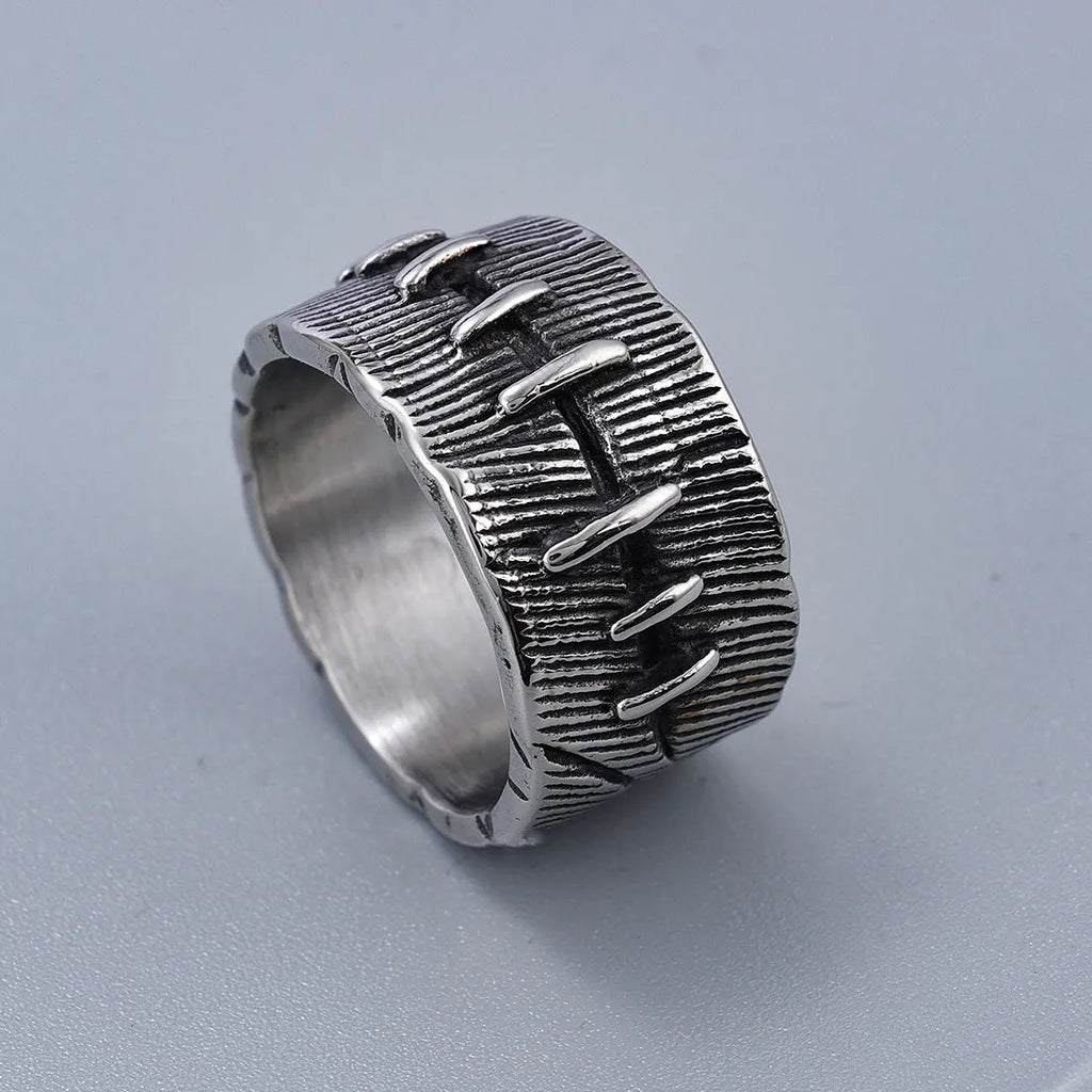 A geometric U-shaped dark punk double ring made from titanium steel in a retro colour, shown on a finger.
