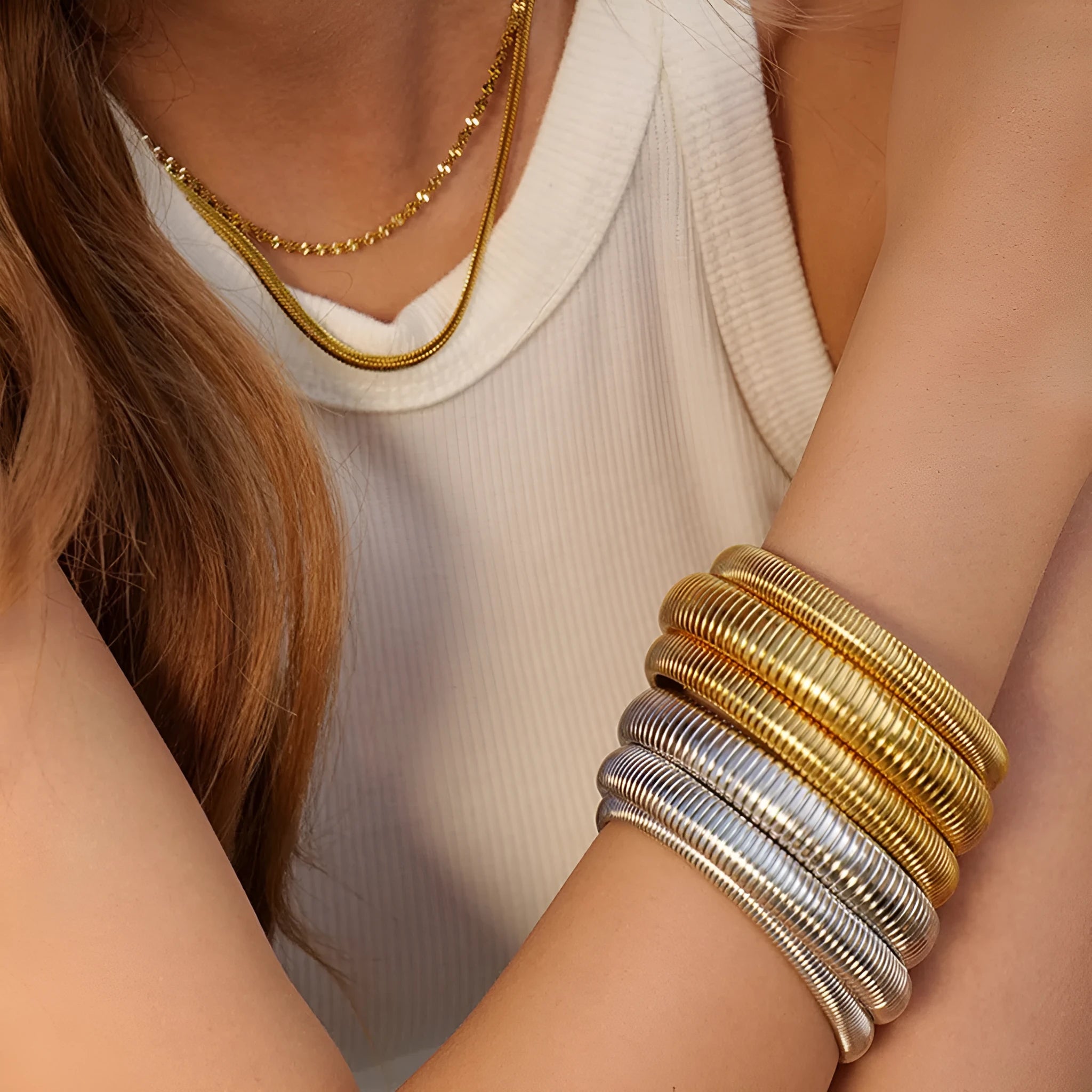 Gold titanium steel bracelet with exaggerated vertical stripe ring pattern and elastic band.