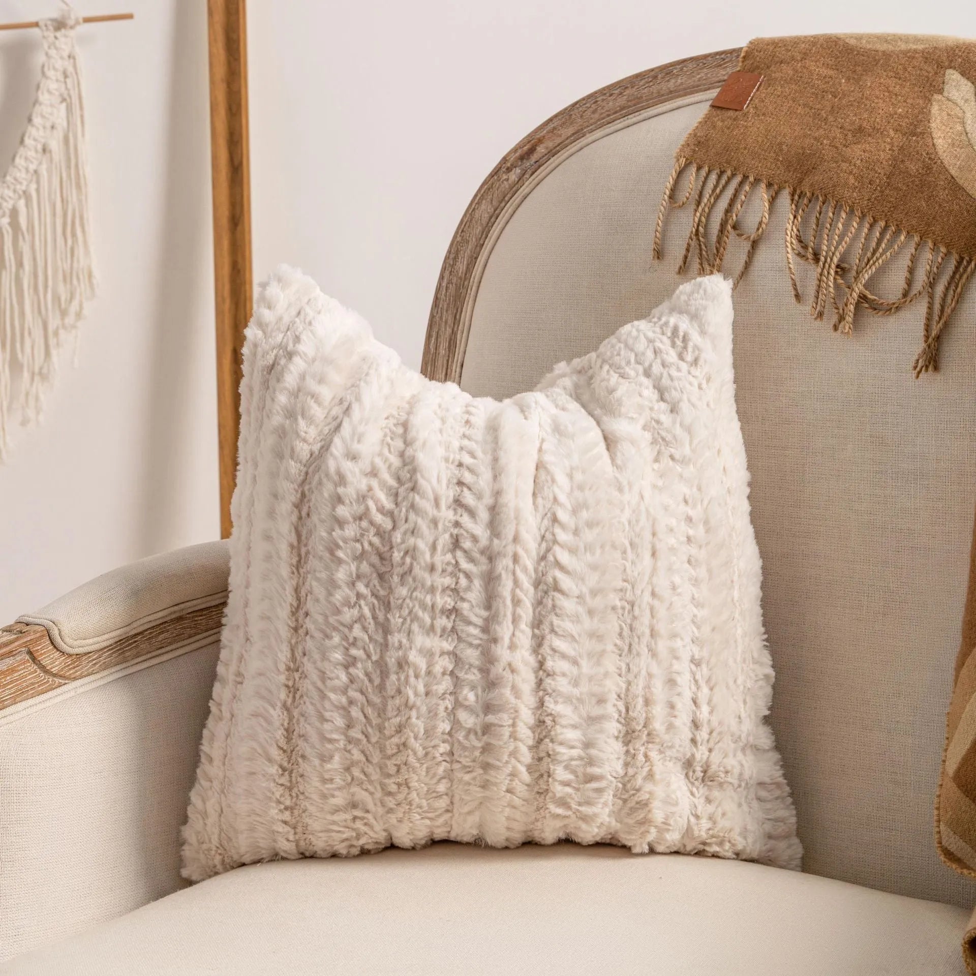Knitted tassel pillow cover with striped pattern and bow design on home sofa