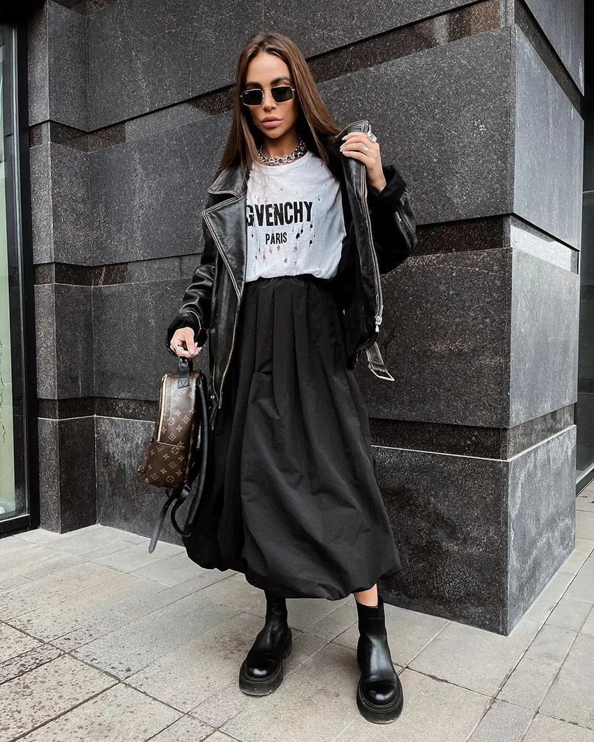 Women's solid colour long cotton skirt in black, shown with a structured fit suitable for casual or commute wear.