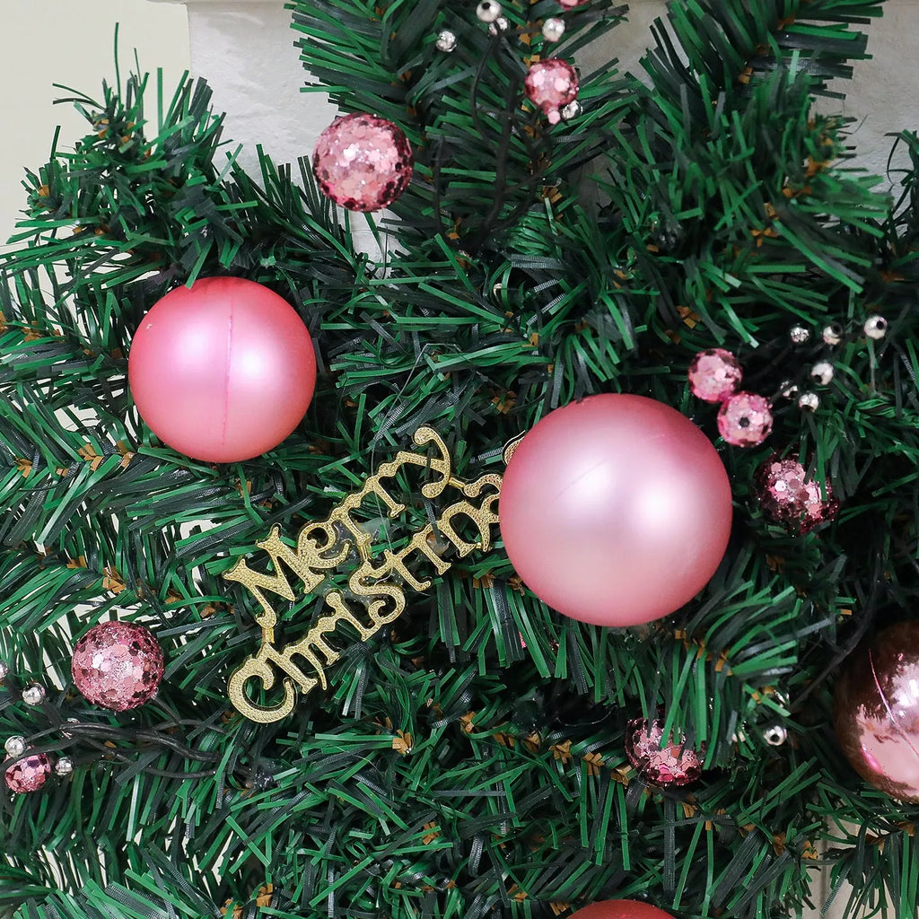 Long pink small fruit rattan Christmas garland draped over a stair bannister with optional LED lights