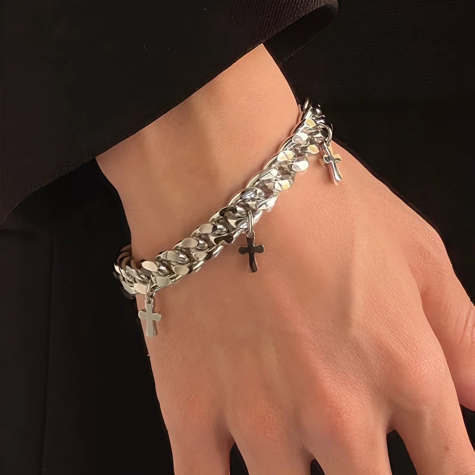 Men's titanium steel bracelet with a cross design and geometric shape on a wrist.