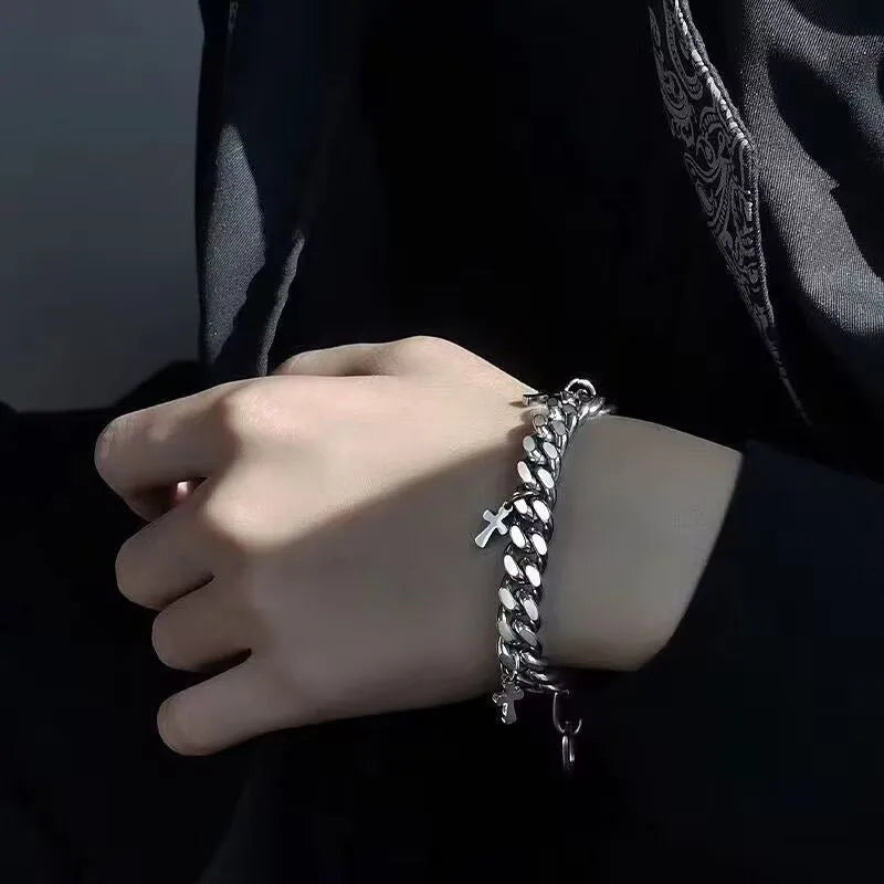 Men's titanium steel bracelet with a cross design and geometric shape on a wrist.