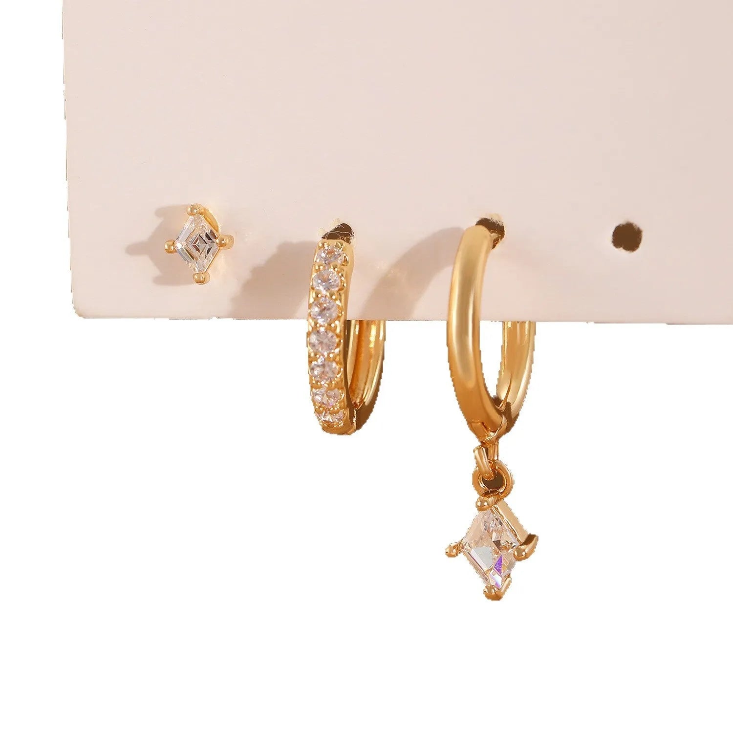 Geometric ladies earring set with zircon detailing in gold and silver options showing drop, stud, and clip-on pieces