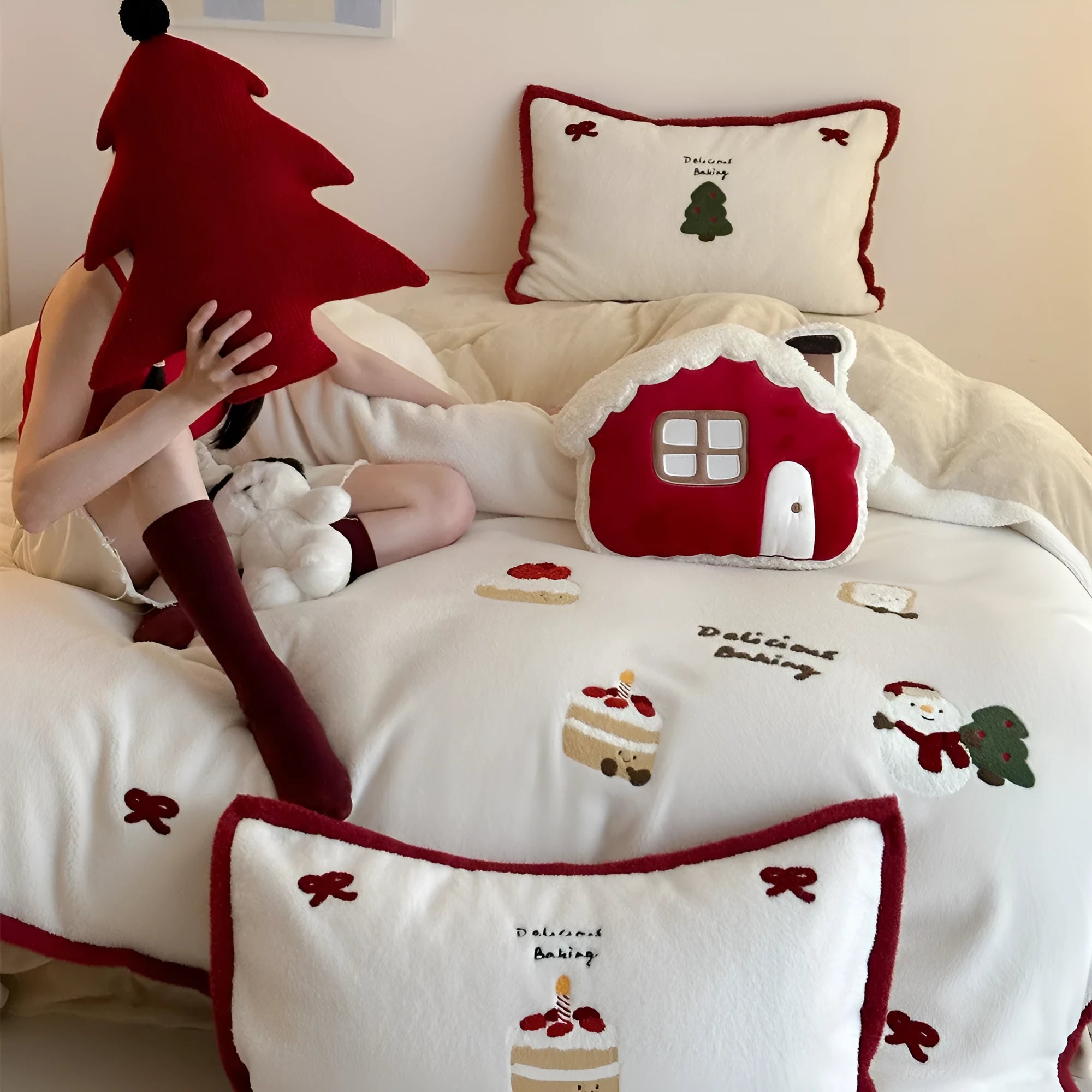 Winter Christmas cartoon patterned bedding four-piece set showing duvet cover, sheet, and pillowcases in pastel colours.