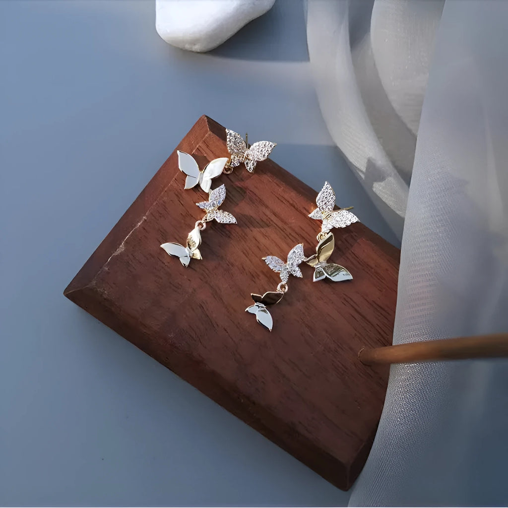 Gold-coloured copper butterfly earrings with four-wing design and drop silhouette for women