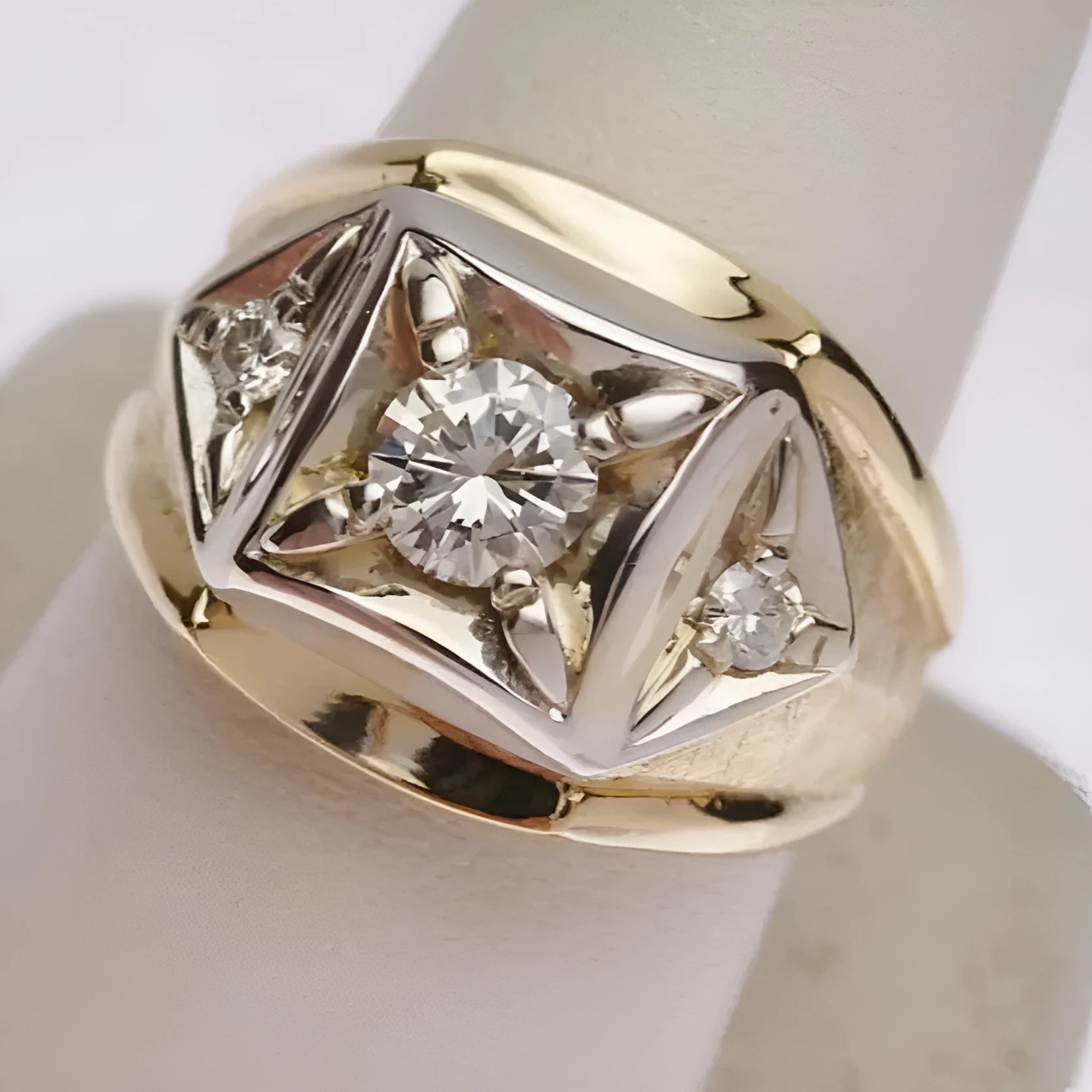 A gold-finished copper couple ring with a wide geometric hollow design and chamfered square pattern.