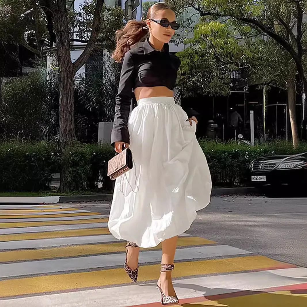 Women's solid colour long cotton skirt in black, shown with a structured fit suitable for casual or commute wear.