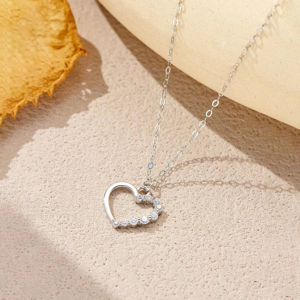 S925 sterling silver hollow heart and circle pendant necklace on a regular chain, shown in two colour finishes.