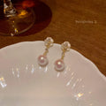 A pair of camellia flower-shaped stud earrings for women in a metallic alloy finish.