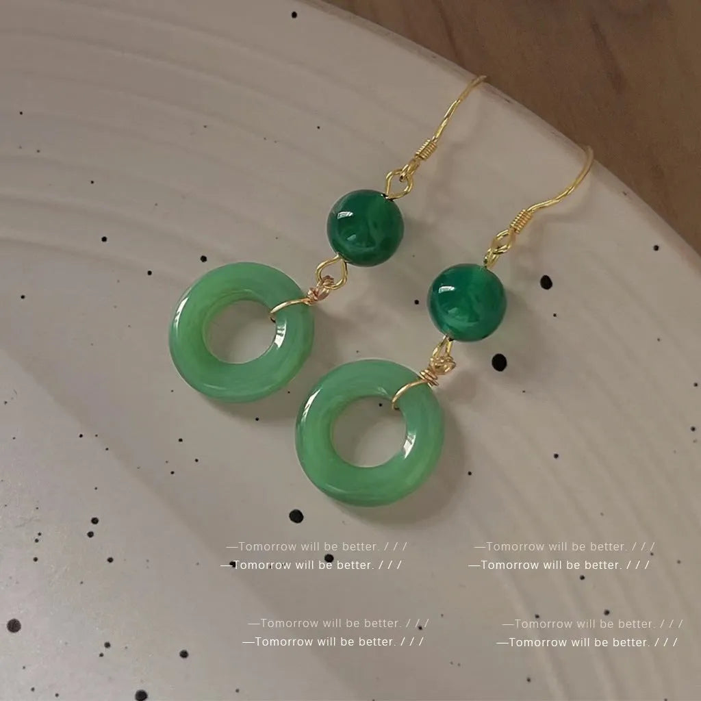 Green Chinese style peace buckle shaped earrings with geometric design and gold plating