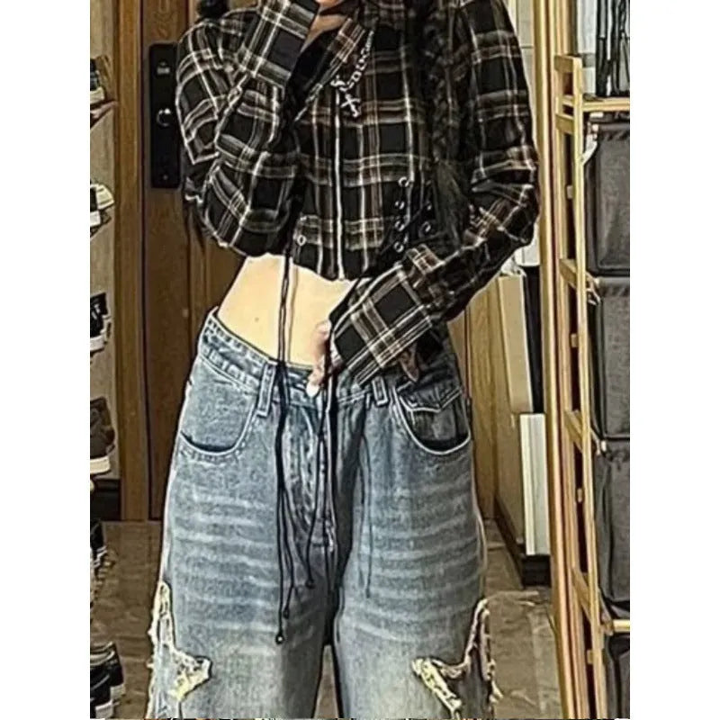 Blue women's high-waist straight-leg jeans laid flat, showing denim texture and button fly.