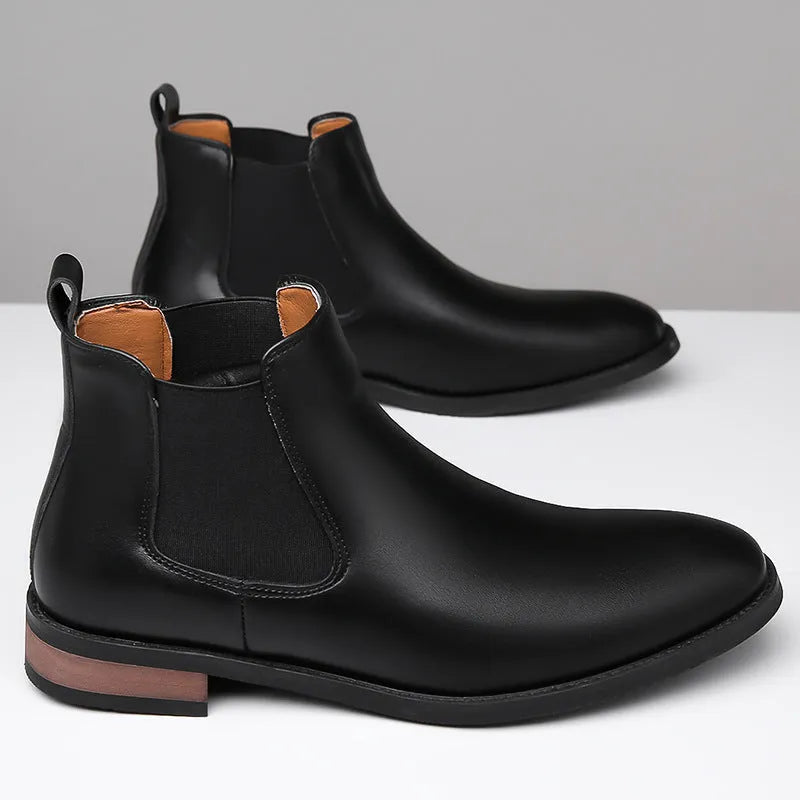 Men's black pointed-toe Chelsea ankle boot with a high-top silhouette and rubber sole.