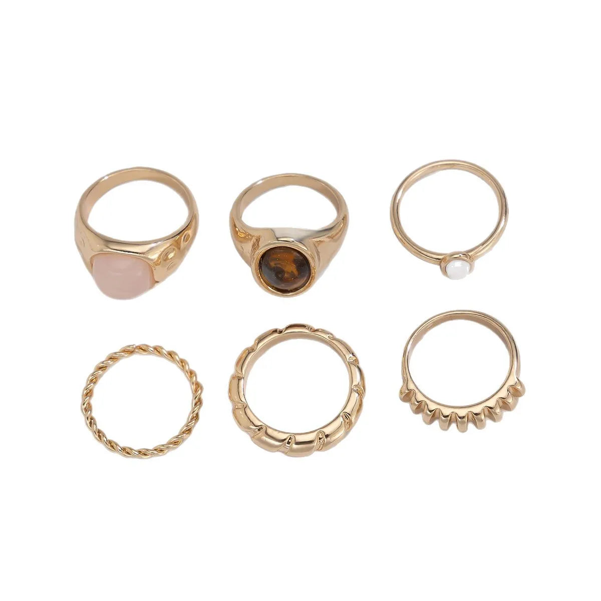 Six geometric alloy rings with light gold electroplated finish arranged as a coordinated set