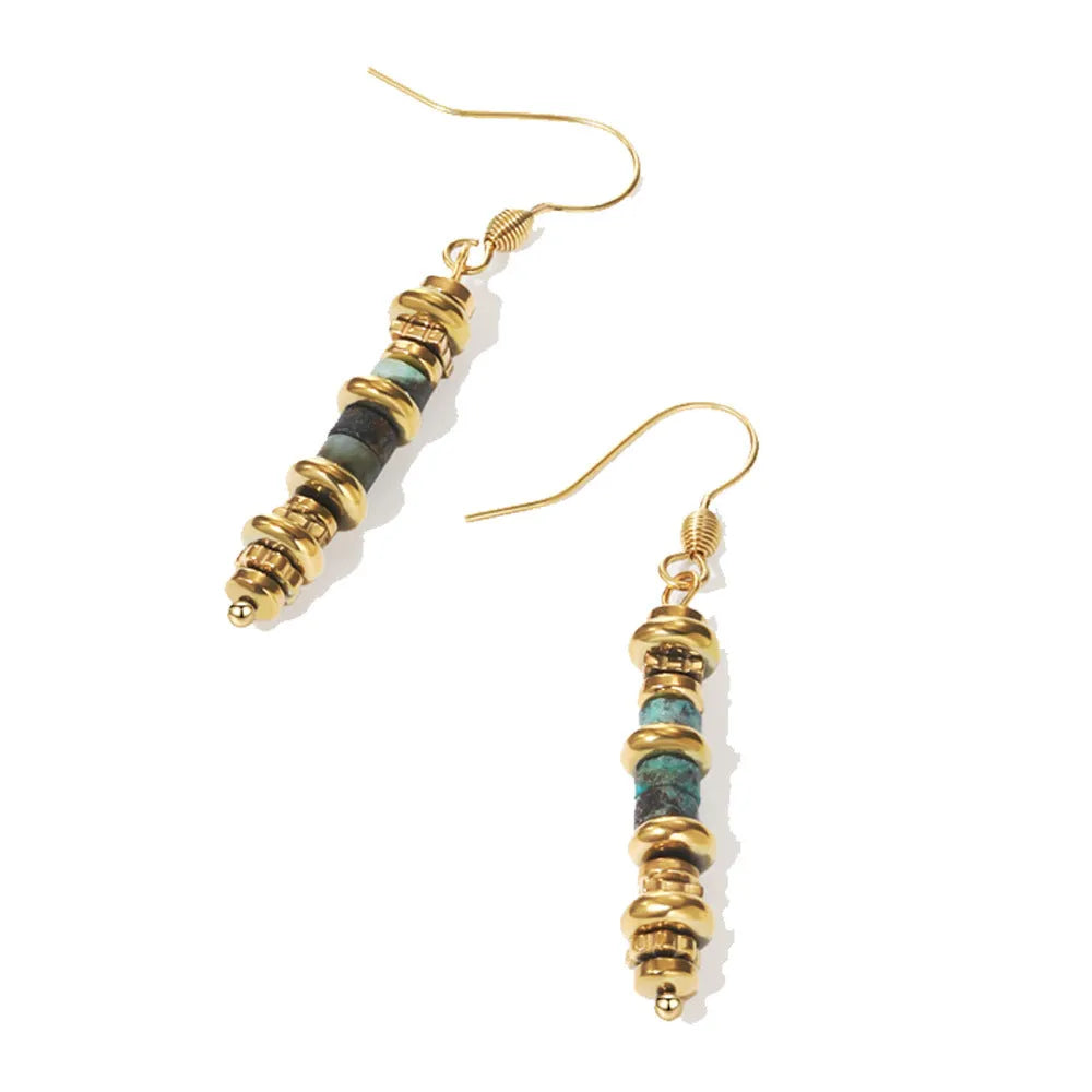 A pair of geometric-shaped, gold-toned dangle earrings on a plain background.