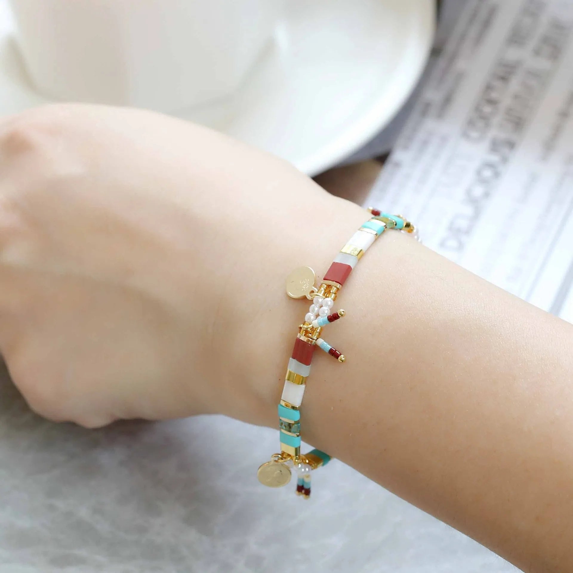 Women's glass coloured beaded bracelet with imitation pearl design showing six colour variations