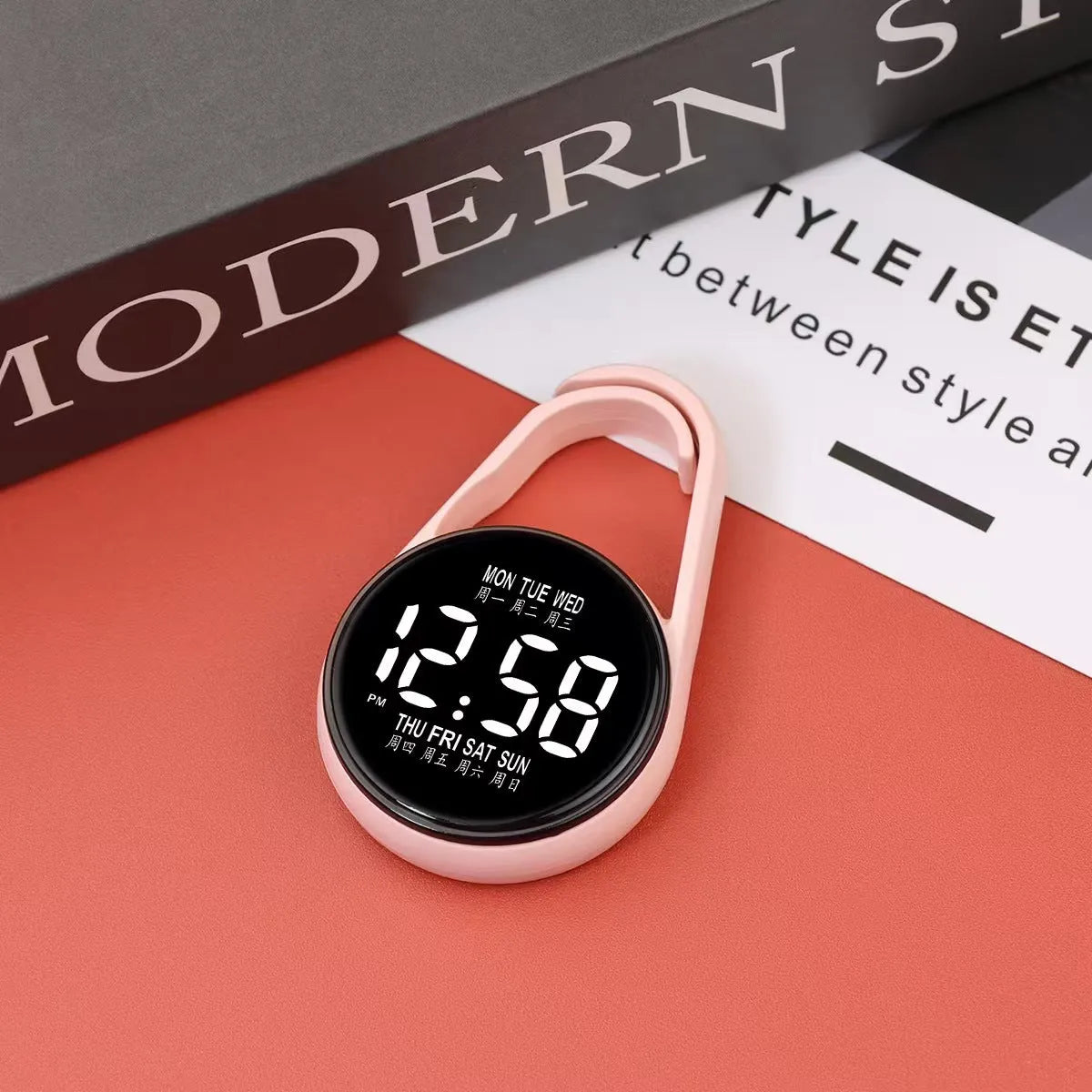 LED luminous electronic digital watch with plastic strap, shown in one of ten available colours on a wrist.