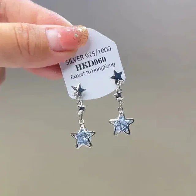 Geometric heart-shaped silver ear clip with rhinestone and dangling star tassel decoration