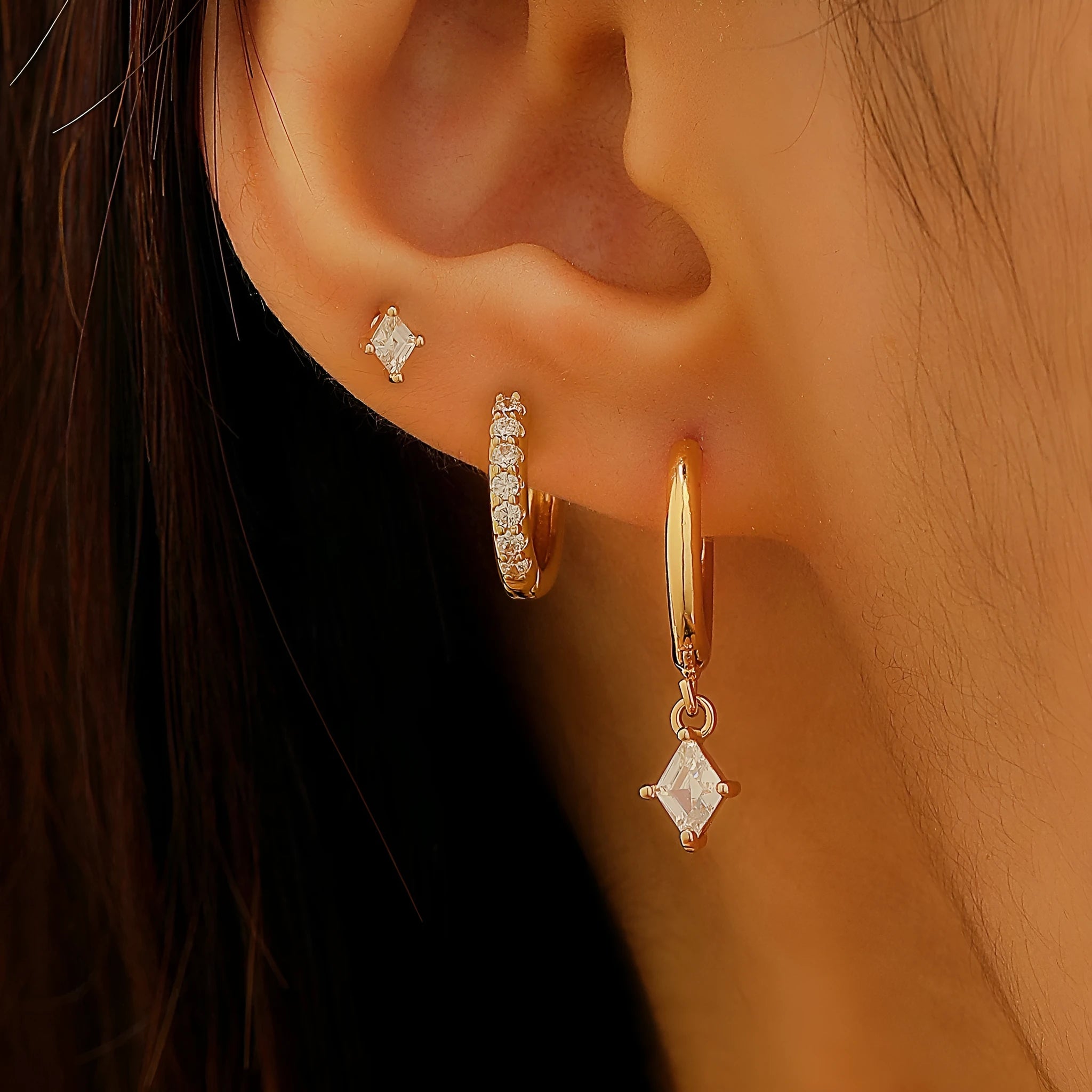 Geometric ladies earring set with zircon detailing in gold and silver options showing drop, stud, and clip-on pieces