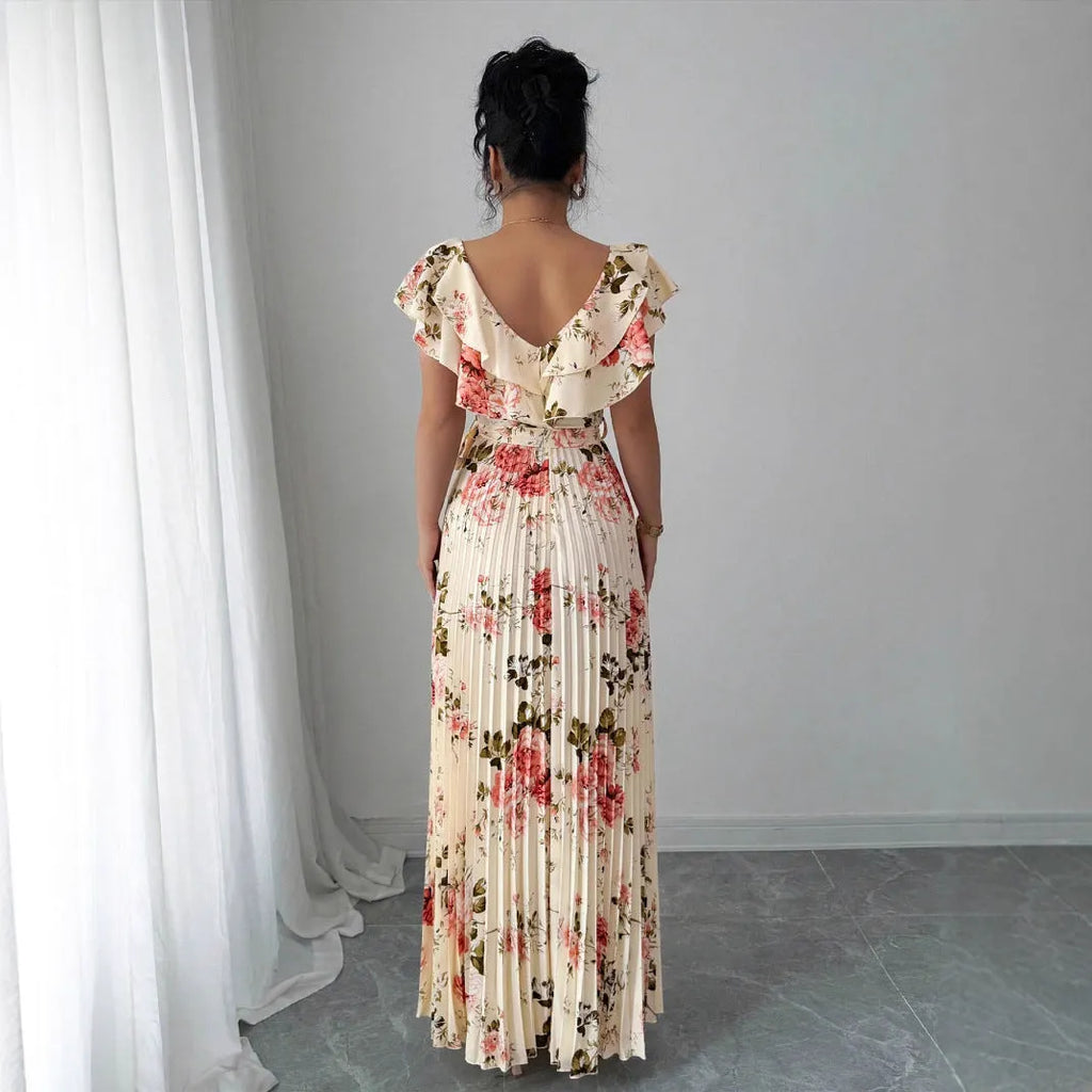Apricot coloured floral print dress with V-neck, ruffled short sleeves, and a high-waisted oversized swing skirt.