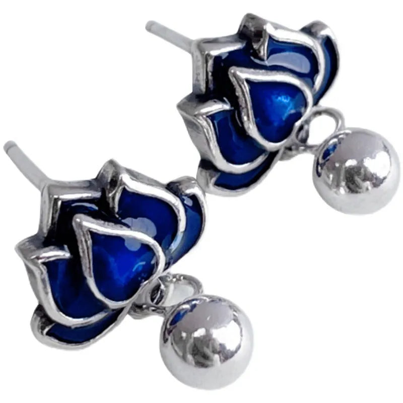 A pair of blue lotus ear studs with a seedpod and tassel design made from alloy.