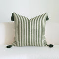 Green patterned cotton linen decorative pillow on a bed, shown in striped, botanical, and leaf designs.