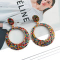 Alloy cartoon pendant earrings with large round coloured pendants and post backs for pierced ears