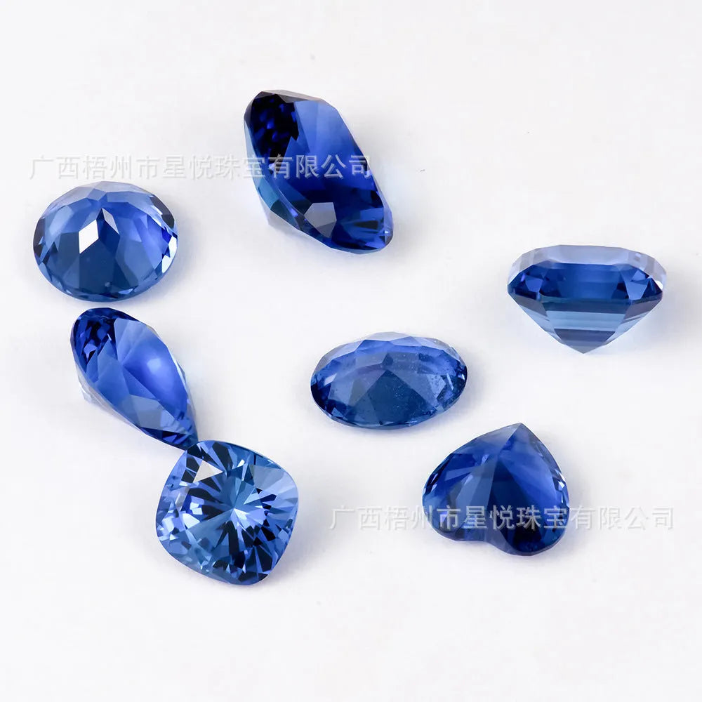 Royal blue love shaped tiara gemstone in heart and round cuts on a grey background.