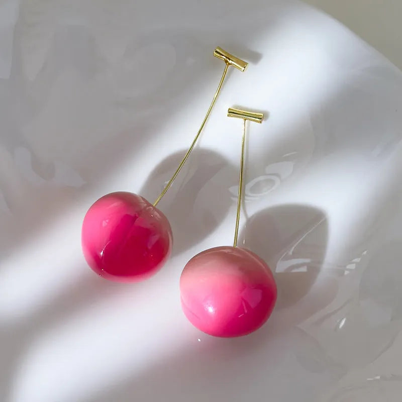 Women's acrylic peach fruit earrings in small and large size options with copper findings