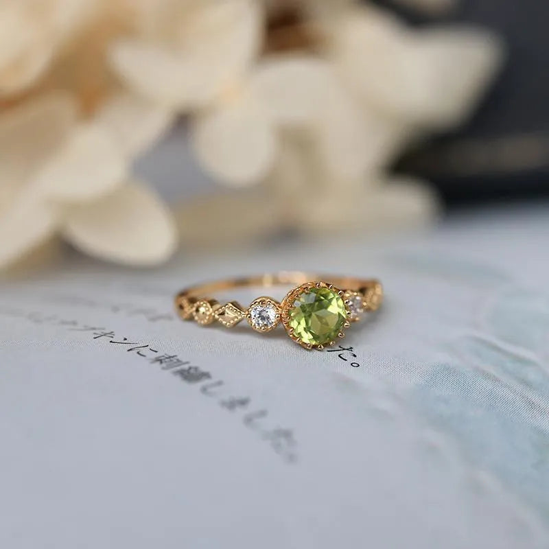 Close-up of a copper ring with a geometric quadrilateral shape and imitation peridot detail.