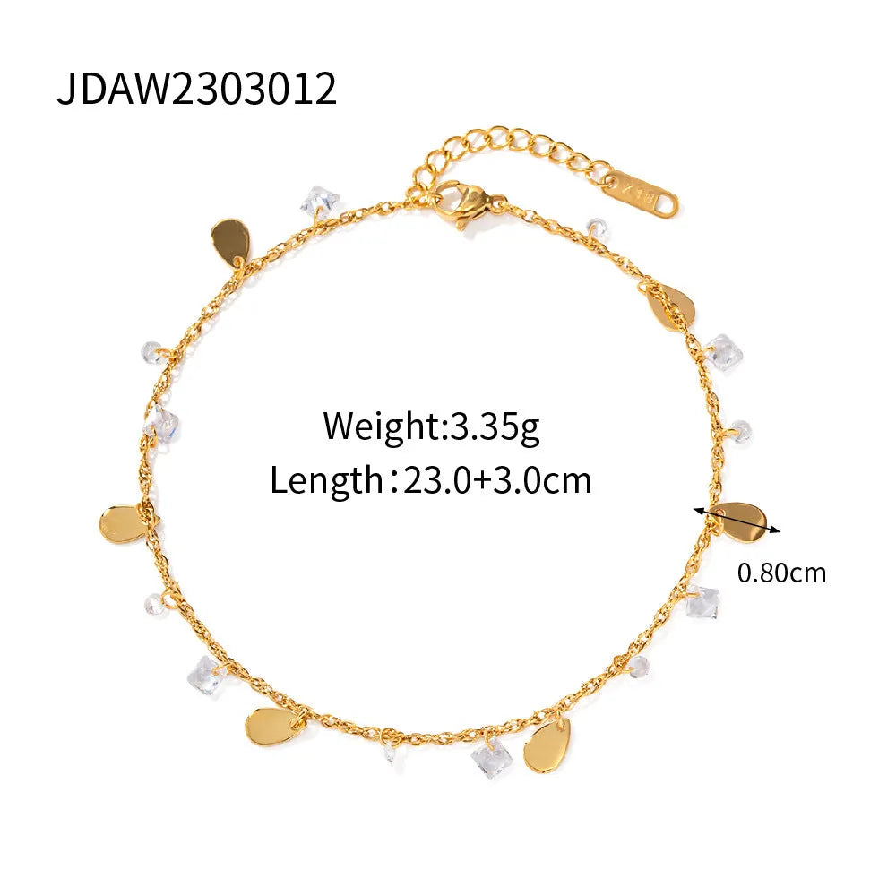 Close-up of a women's stainless steel anklet with a water drop pendant and tassel detail.