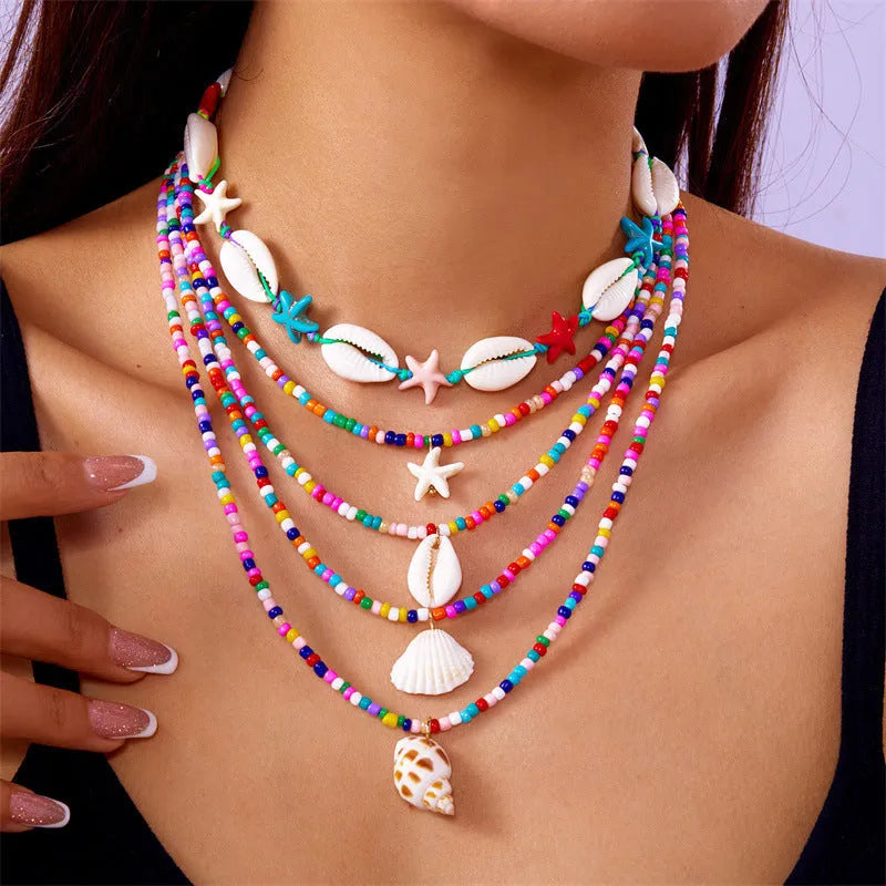 Women's multi-layer necklace set with starfish and shell bead pendants on adjustable chain