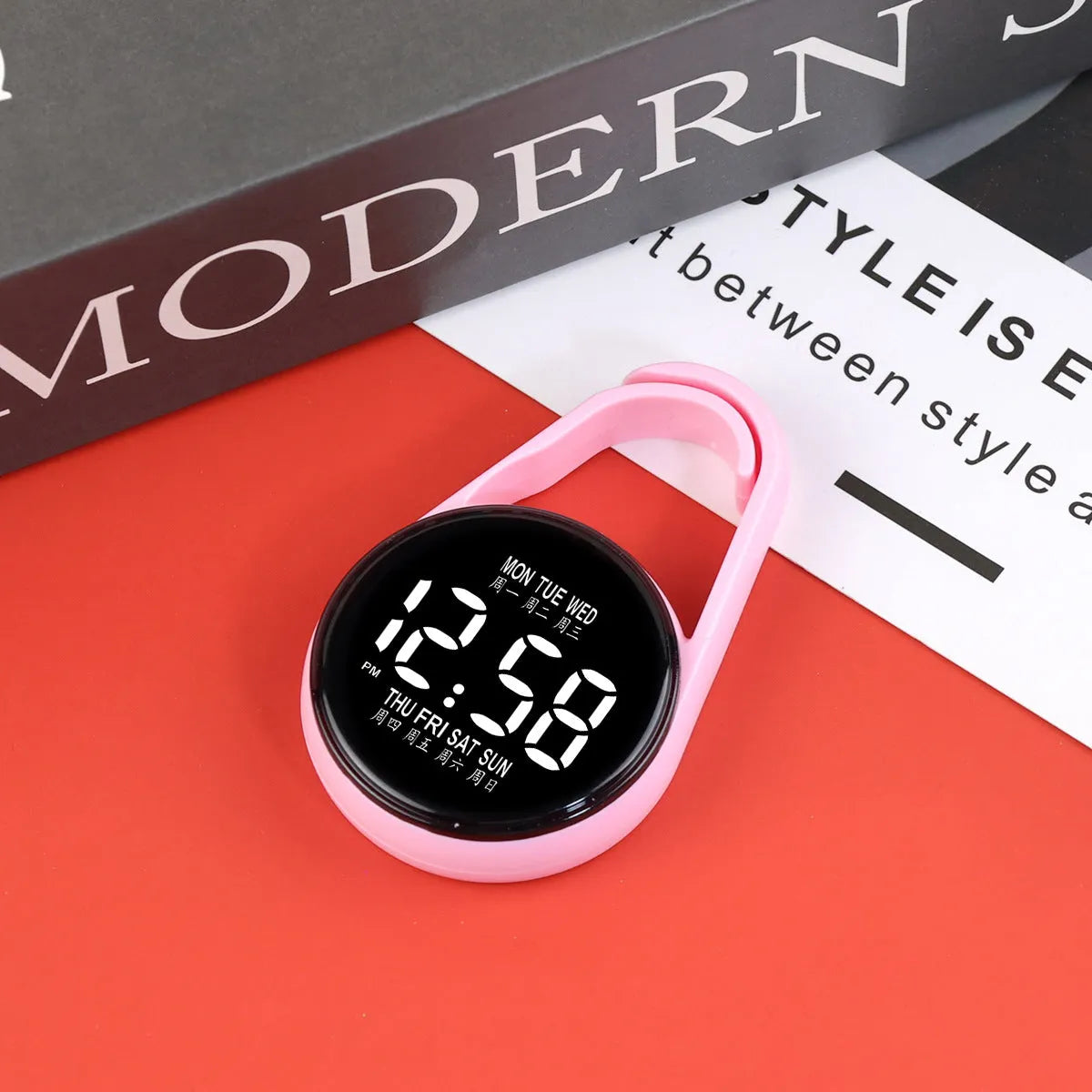 LED luminous electronic digital watch with plastic strap, shown in one of ten available colours on a wrist.