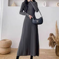 Women's beige high-waist knitted A-line midi dress with regular sleeves on a model.