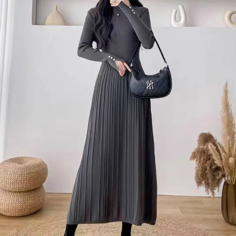 Women's beige high-waist knitted A-line midi dress with regular sleeves on a model.