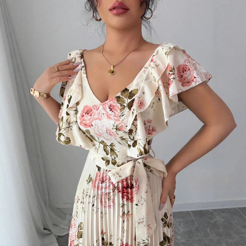 Apricot coloured floral print dress with V-neck, ruffled short sleeves, and a high-waisted oversized swing skirt.