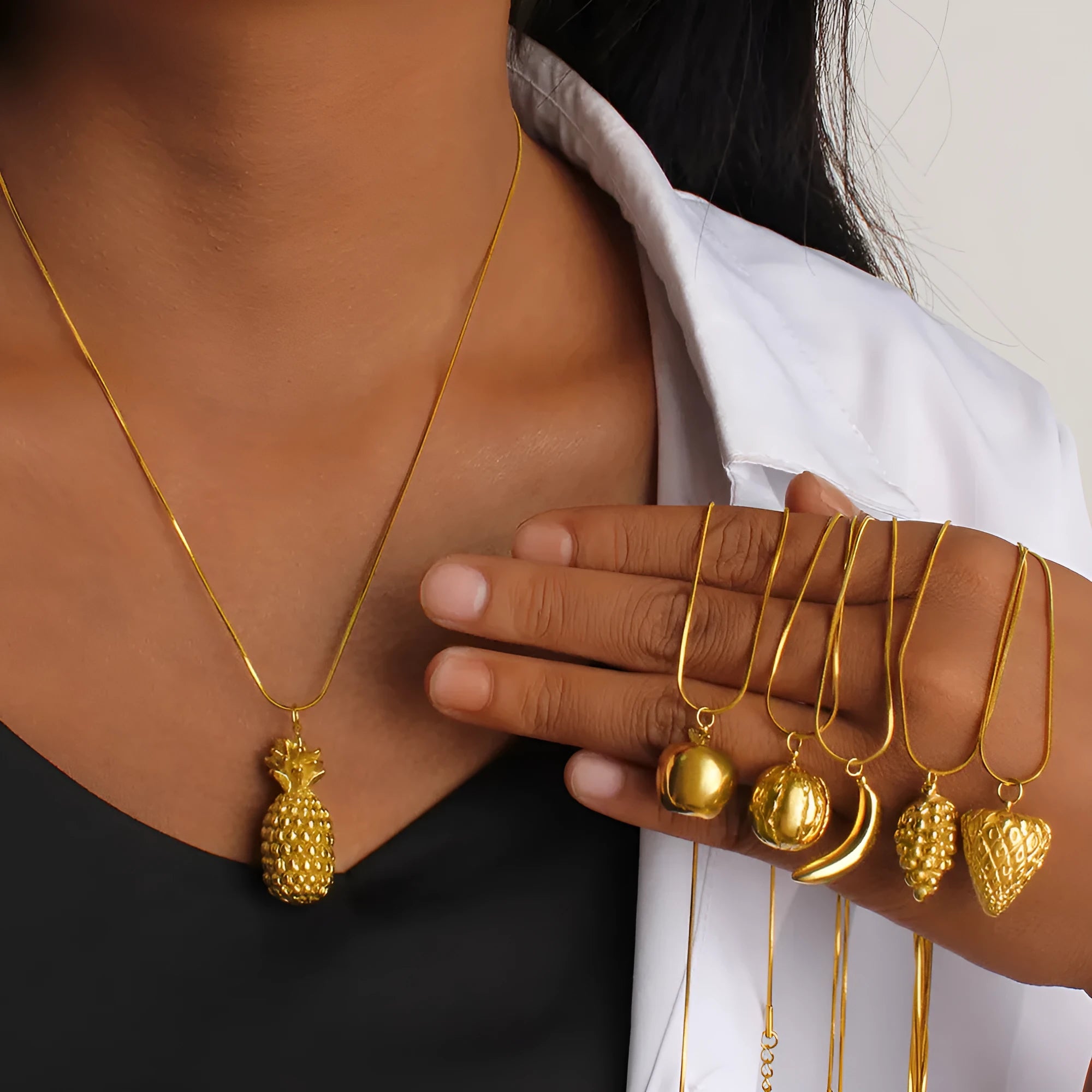 Stainless steel necklace with a fruit-shaped pendant on a regular chain.