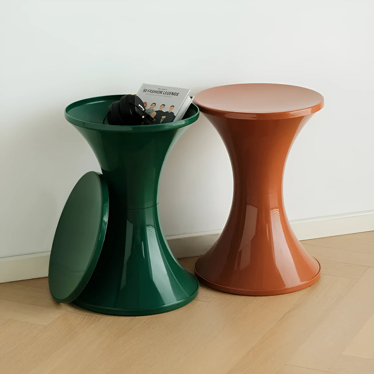 A plastic hourglass-shaped stool for changing shoes, shown in a green colour variant.
