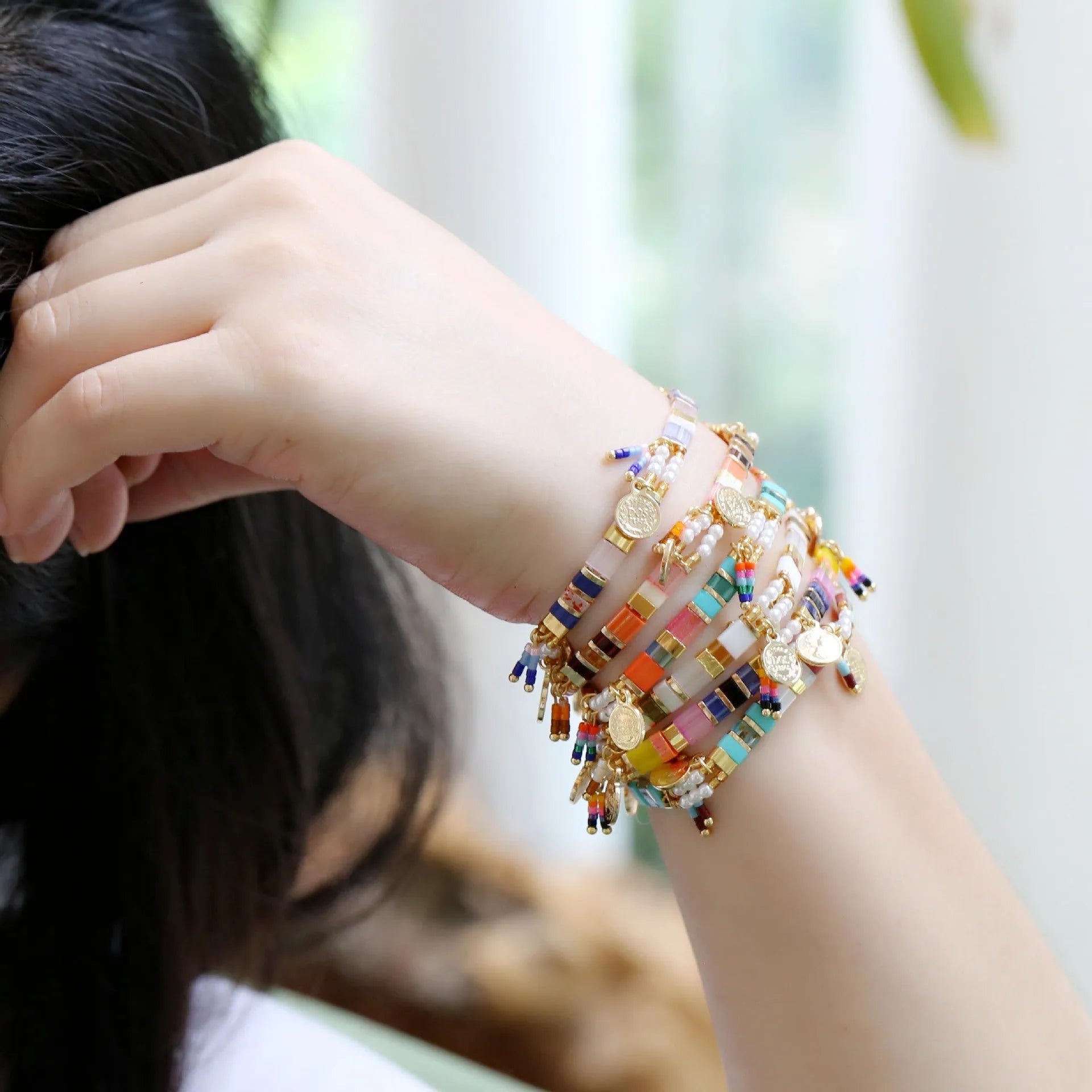 Women's glass coloured beaded bracelet with imitation pearl design showing six colour variations
