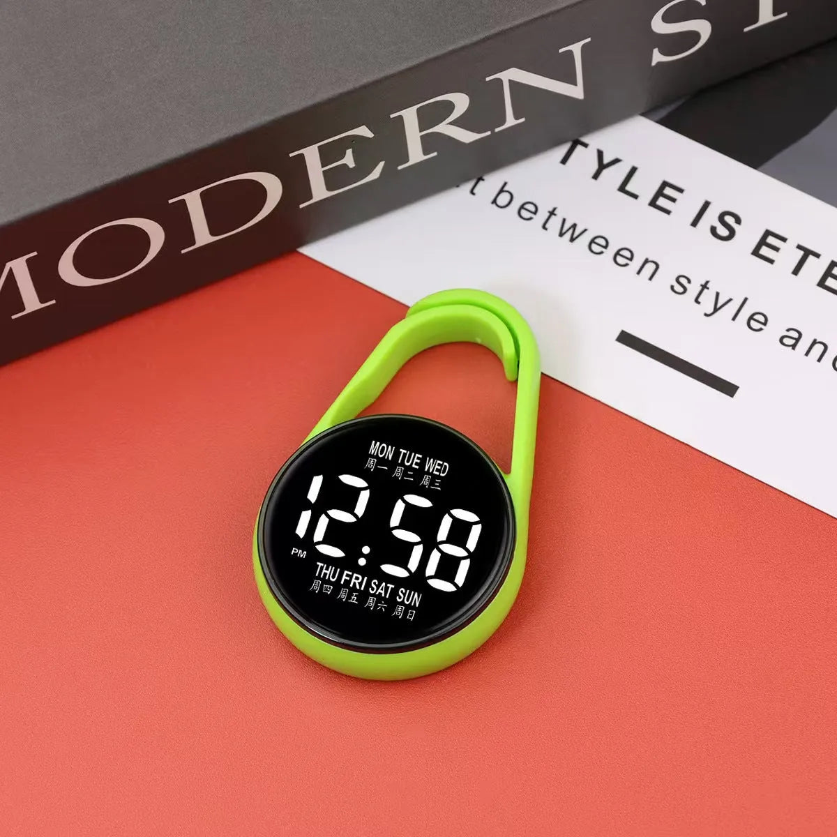 LED luminous electronic digital watch with plastic strap, shown in one of ten available colours on a wrist.