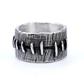 A geometric U-shaped dark punk double ring made from titanium steel in a retro colour, shown on a finger.