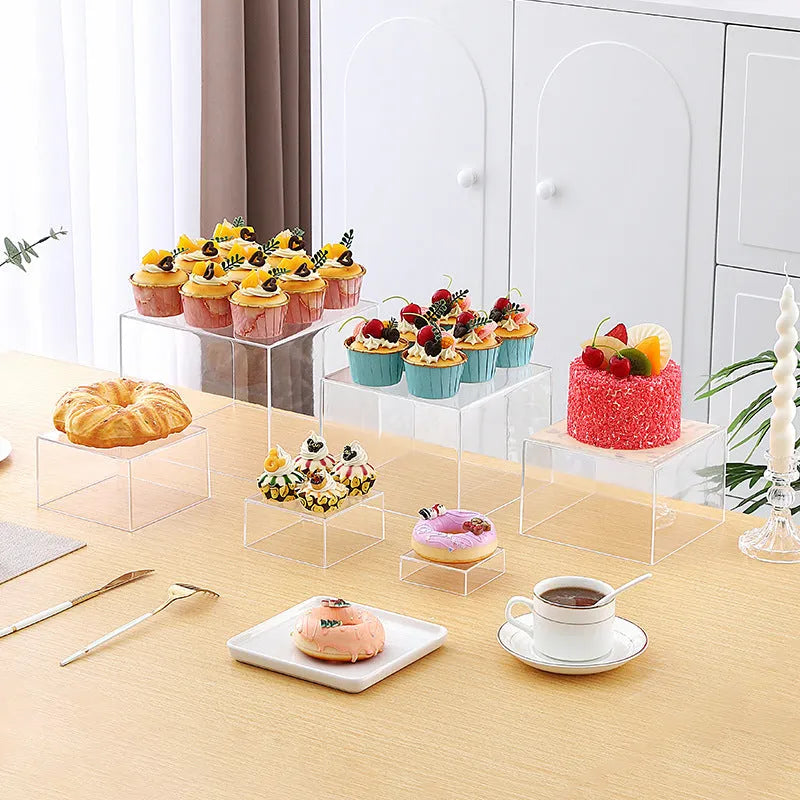 White plastic 6-piece interlocking cube dessert display stand showing tiered arrangement.