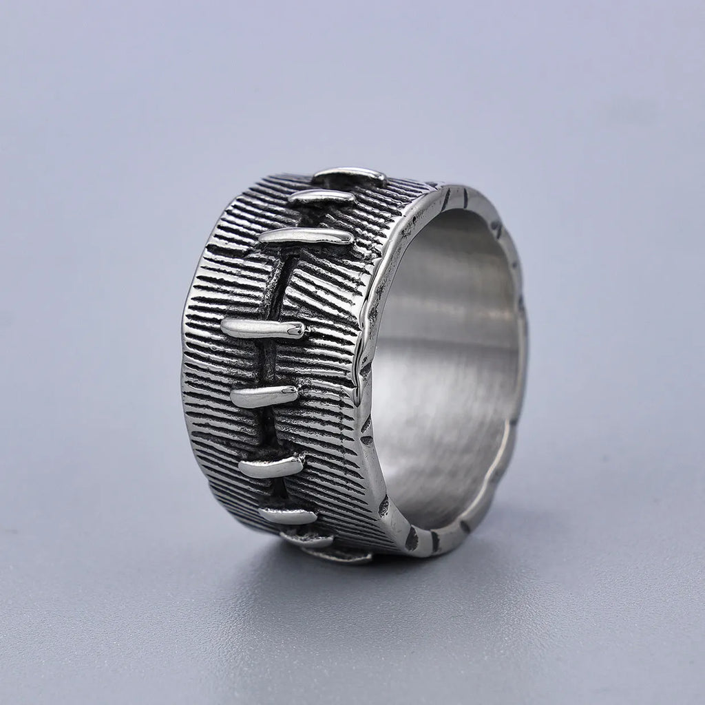 A geometric U-shaped dark punk double ring made from titanium steel in a retro colour, shown on a finger.