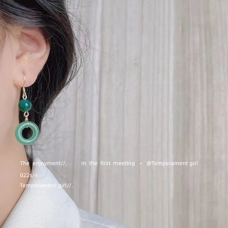 Green Chinese style peace buckle shaped earrings with geometric design and gold plating