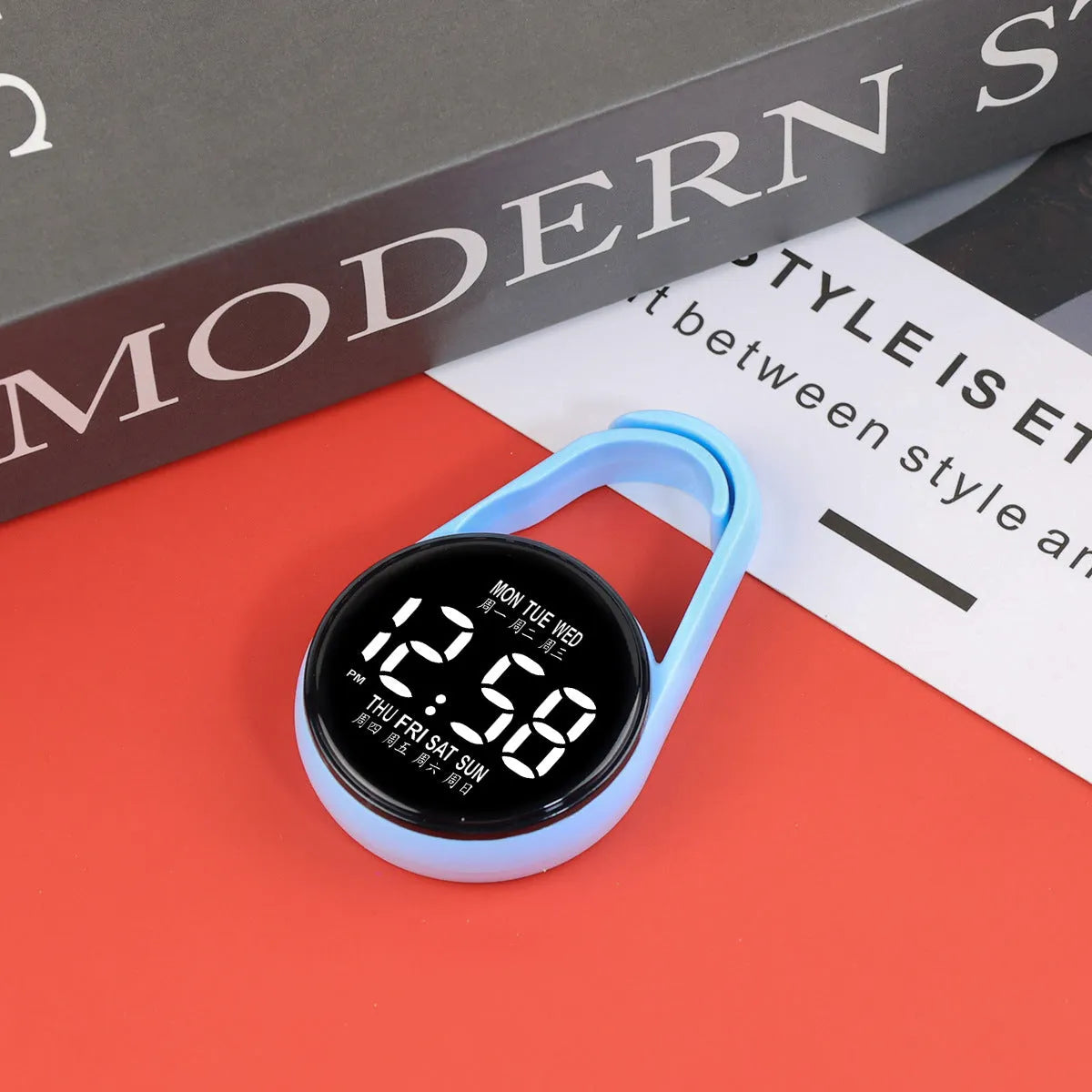 LED luminous electronic digital watch with plastic strap, shown in one of ten available colours on a wrist.