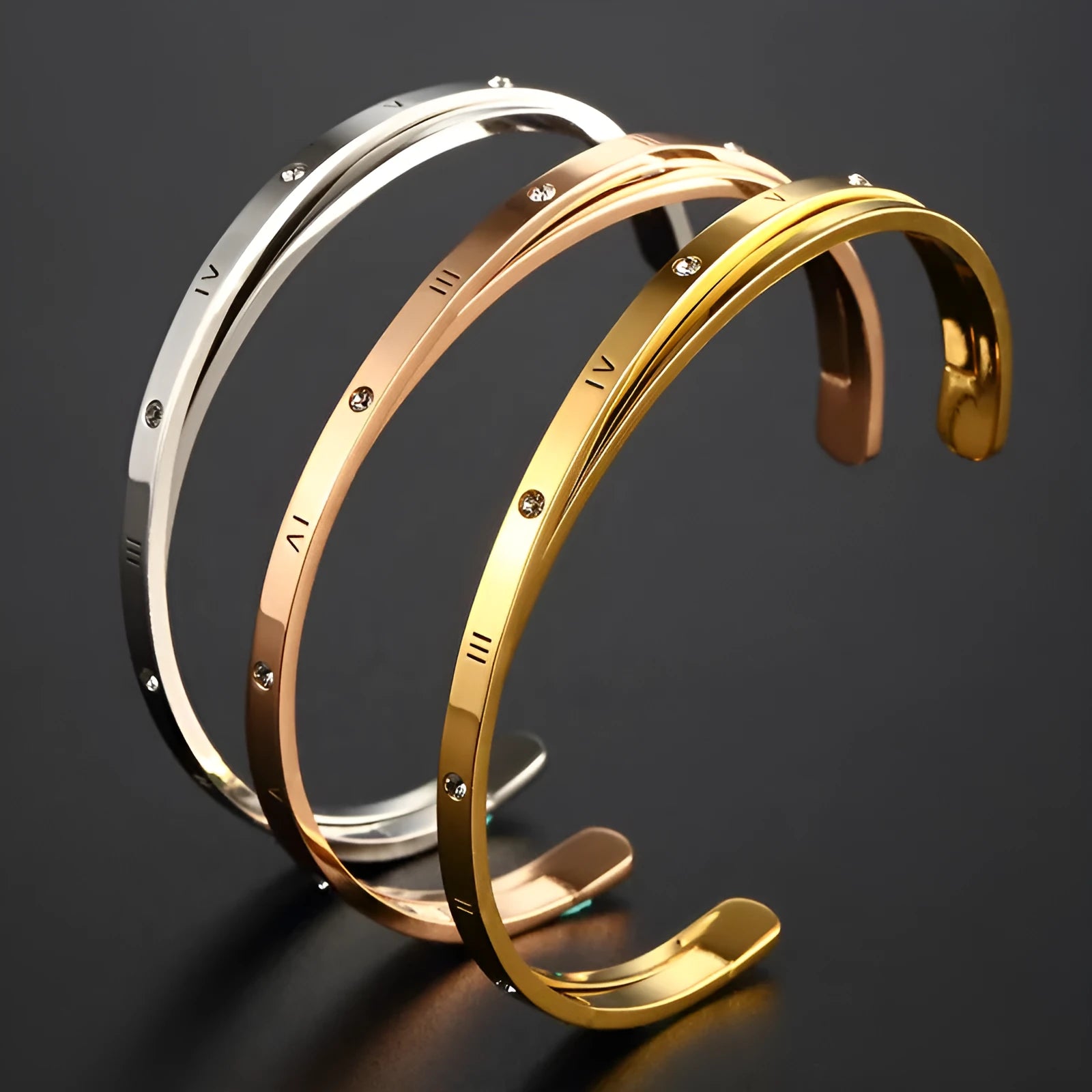 Open-ended stainless steel bracelet with inlaid zircon stones available in gold, rose, and steel colours