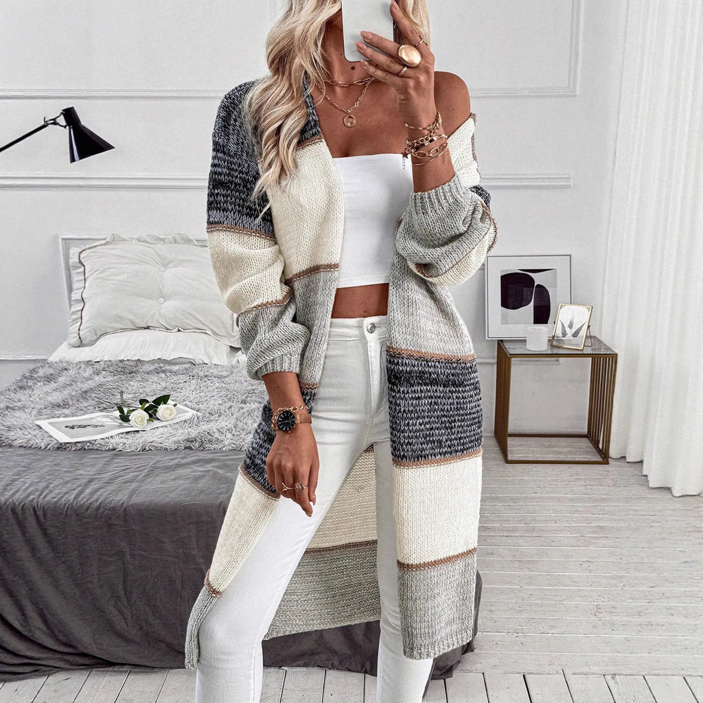 Gray women's knitted long cardigan with loose fit and long sleeves.